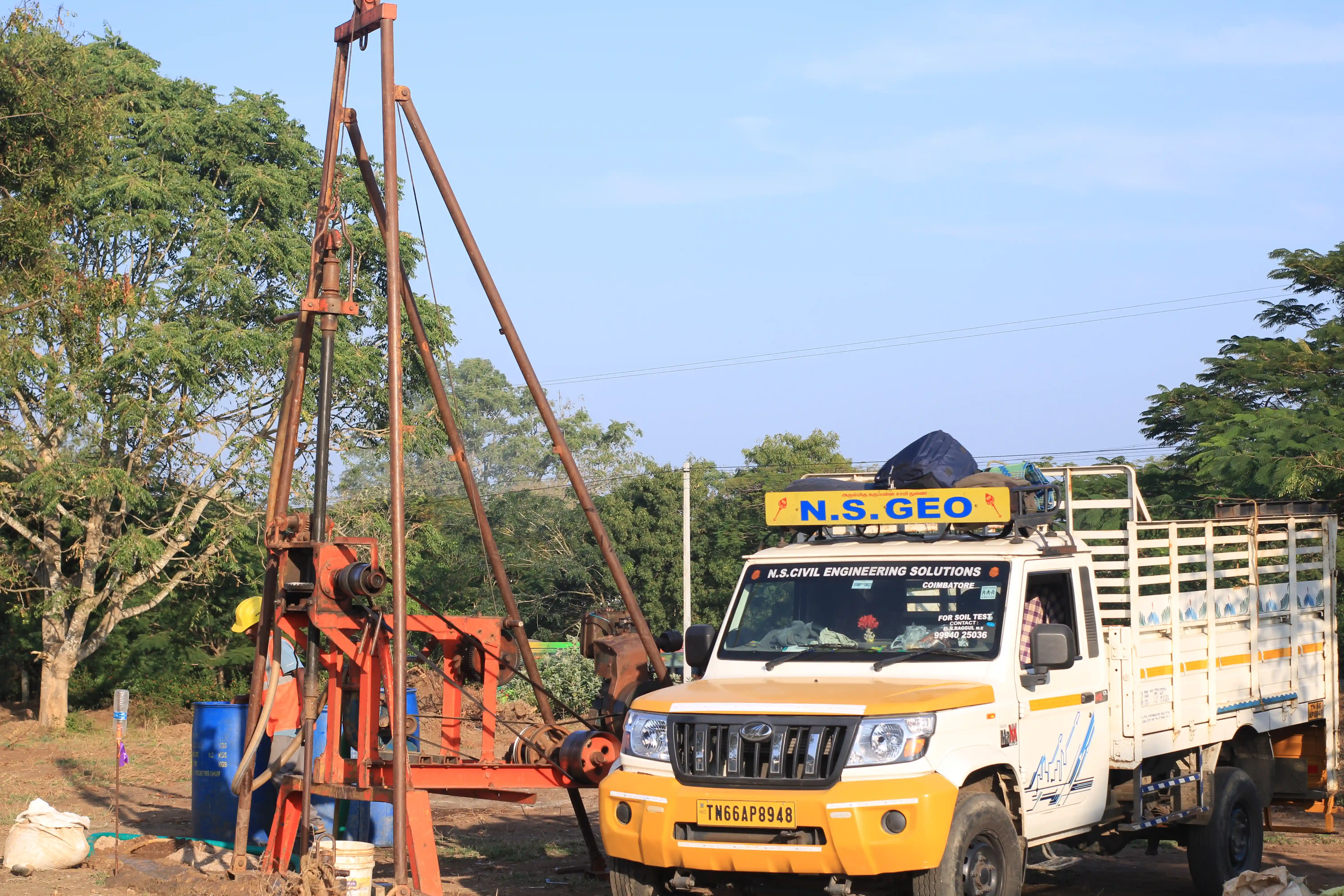 Soil rig in operation with workers